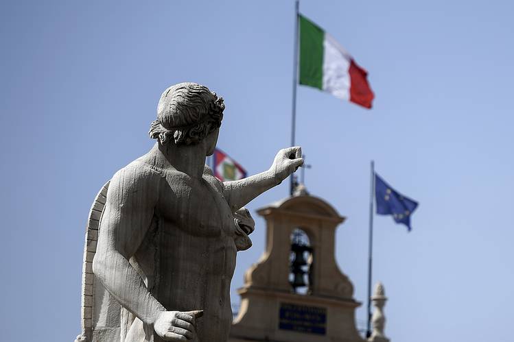 statue in italy with government building and flags
